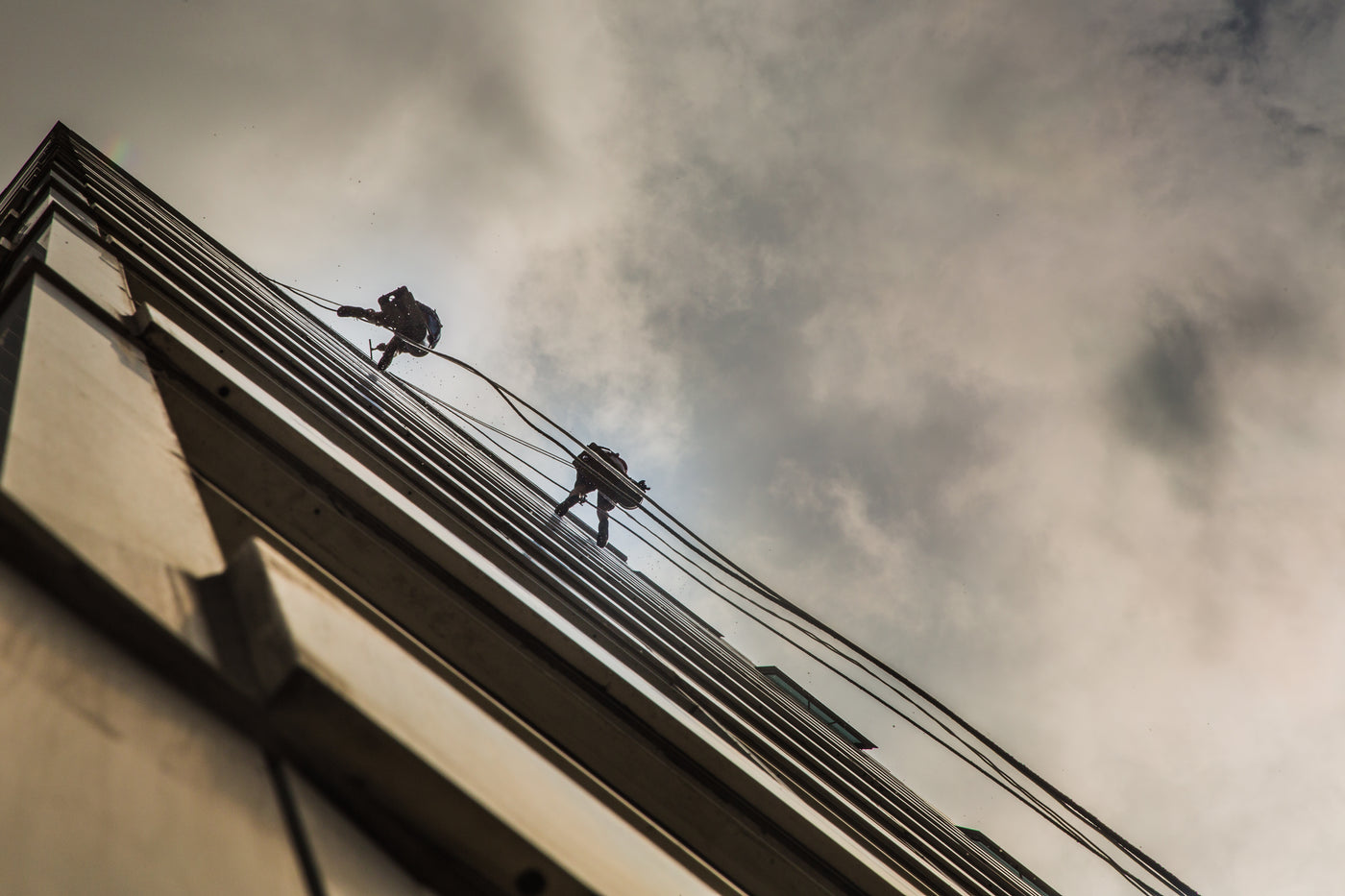 Window cleaners working on a city building